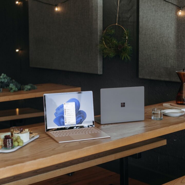 Two Microsoft laptops on a table in an office during the holidays